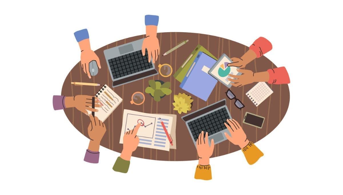Illustration of a team collaborating around a table with laptops, charts, and notebooks.