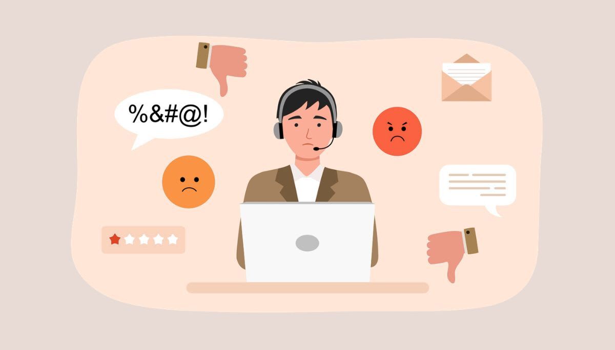 Customer service representative with headset at laptop surrounded by negative feedback icons, symbolizing complaint management software.