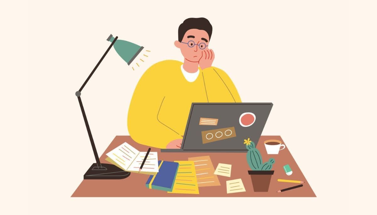 Workspace scene with laptop, documents, and coffee, representing challenges in remote‑first organizations.