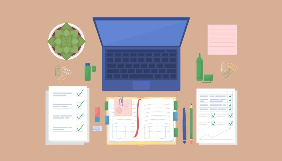 Organized workspace with a laptop, planner, and neatly arranged documents.