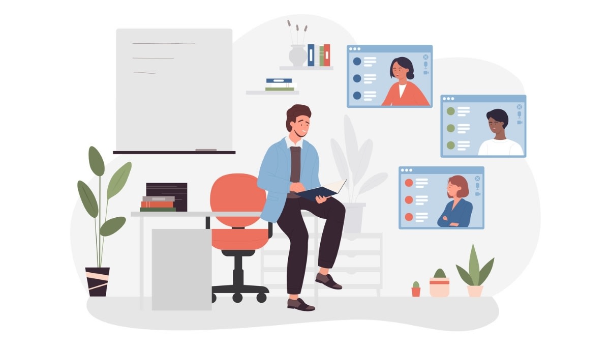 Photo of a man presenting from a desk with virtual screens showing remote participants.