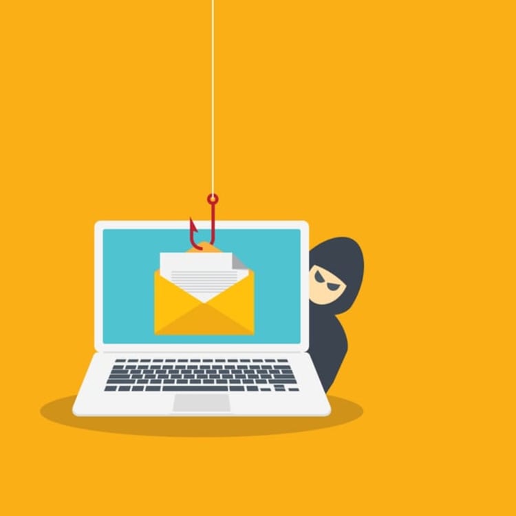 Laptop with email hooked by phishing line and hacker in background, illustrating common characteristics of phishy emails and online scam tactics.
