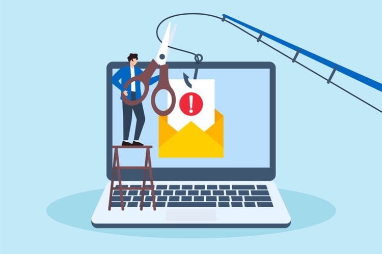 Person cutting warning message from email on laptop while phishing hook approaches, illustrating steps to take when receiving a phishy email or scam attempt.