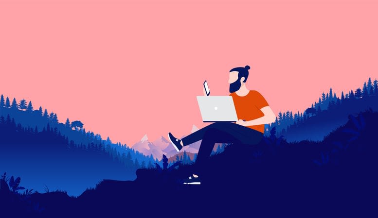 Bearded man with laptop and smartphone working outdoors in nature with landscape