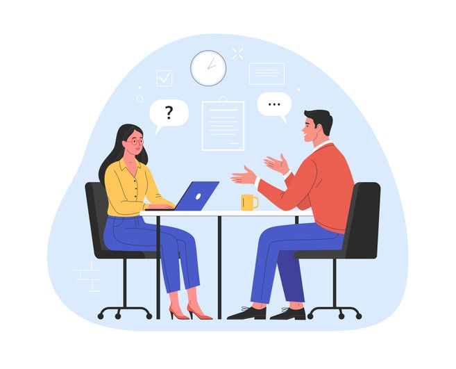 man talking to a young woman with laptop